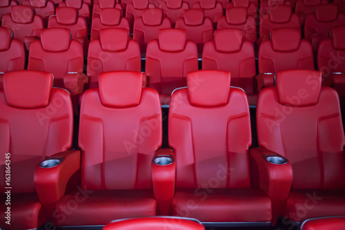Red seat in the movie theater. Blurry background.