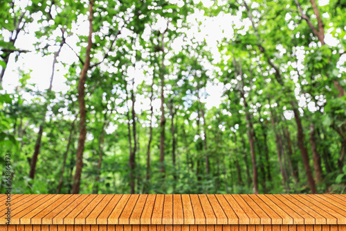 wooden table with green blur natural background