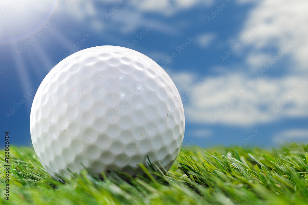 golf ball on grass with blue sky golf ball on grass with blue sky