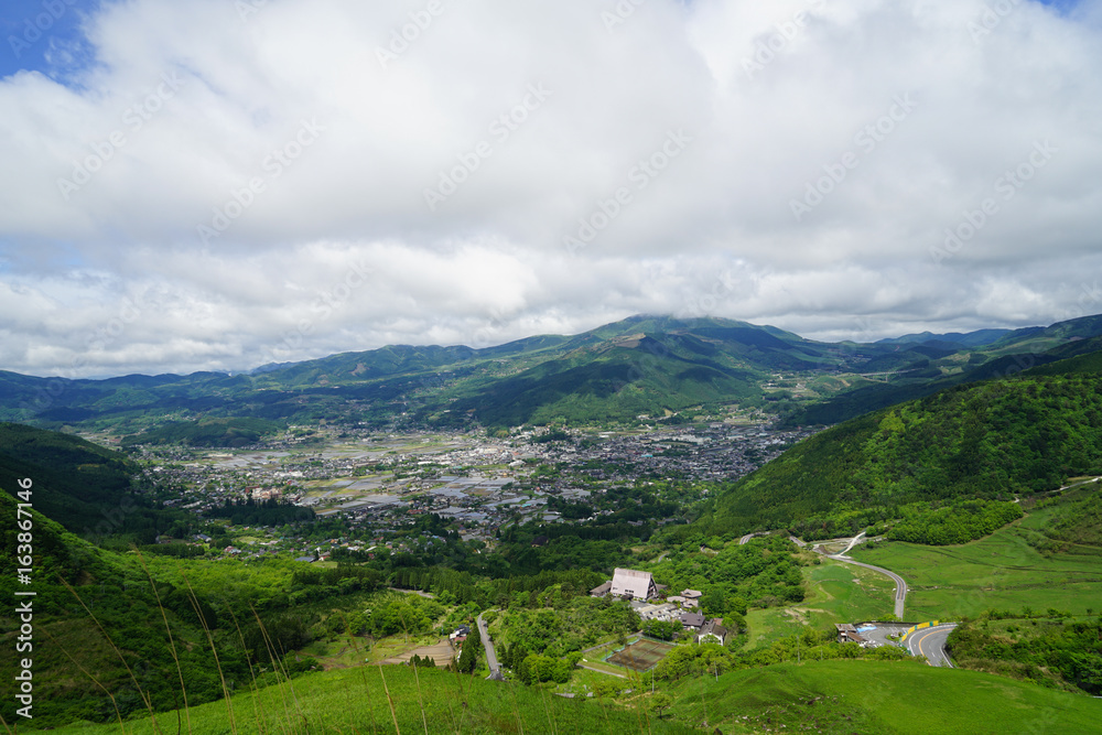 Greenery mountain landscape panorama and town view with white cloudy sky