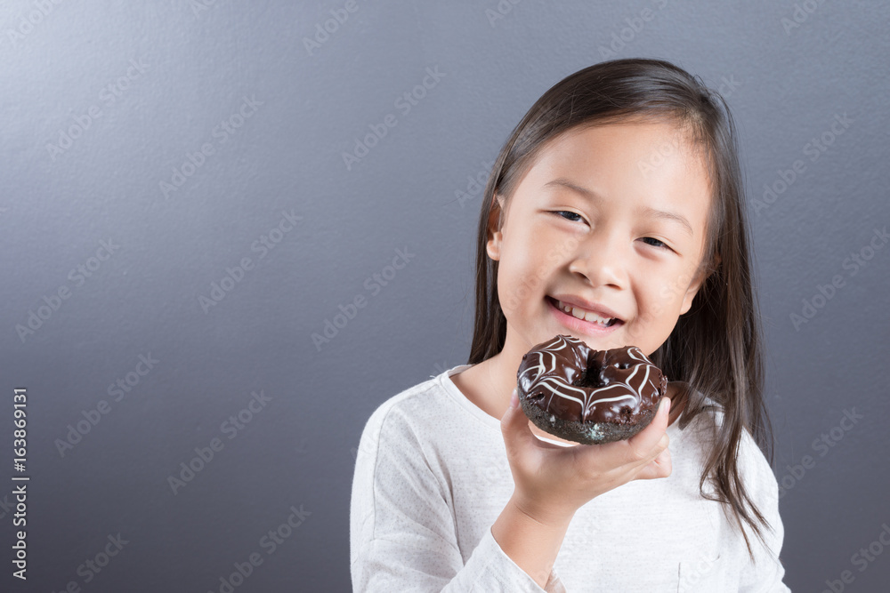 Asian kid girl happy to eat doughnut and milk Asian kid girl happy to eat doughnut and milk