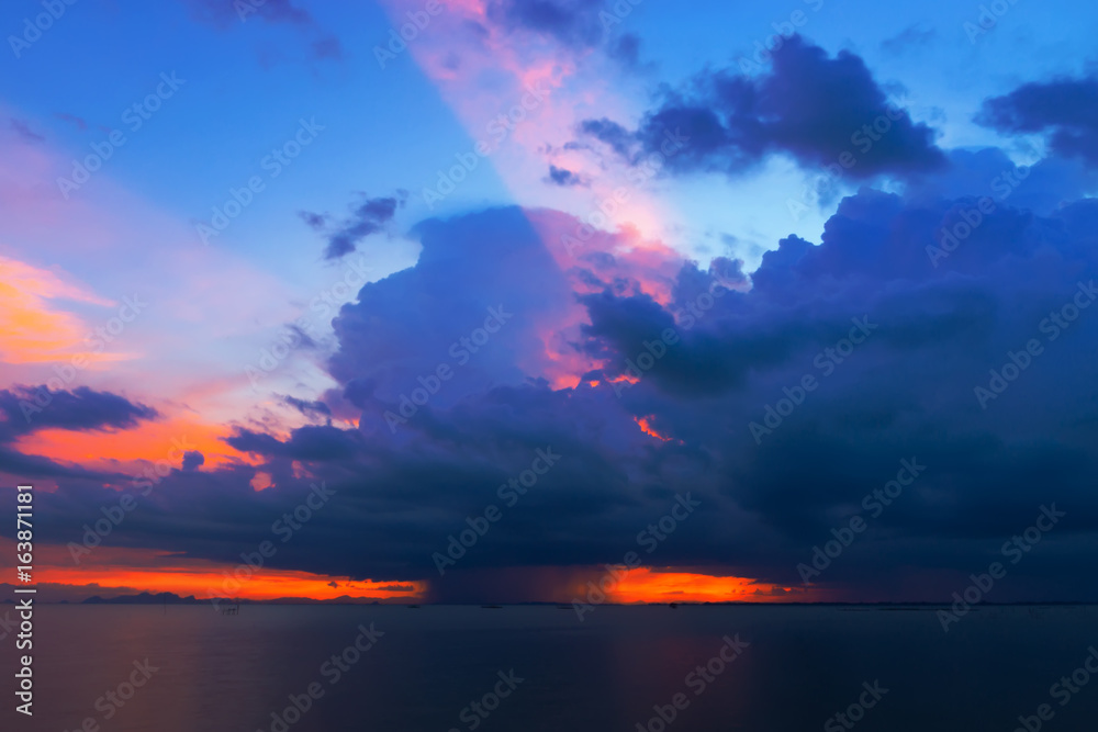 Sunset sky at the lake with rain cloud.