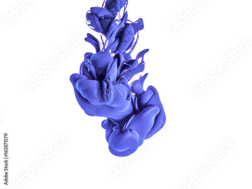 Ink swirl in a water, isolated on white background. The blue paint in the water. Soft dissemination a droplets of colored ink in water close-up. Explosion of color splashes acrylic ink.