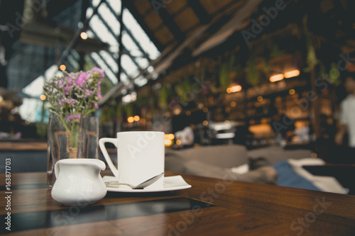 Coffee notebook and glass on wooden table