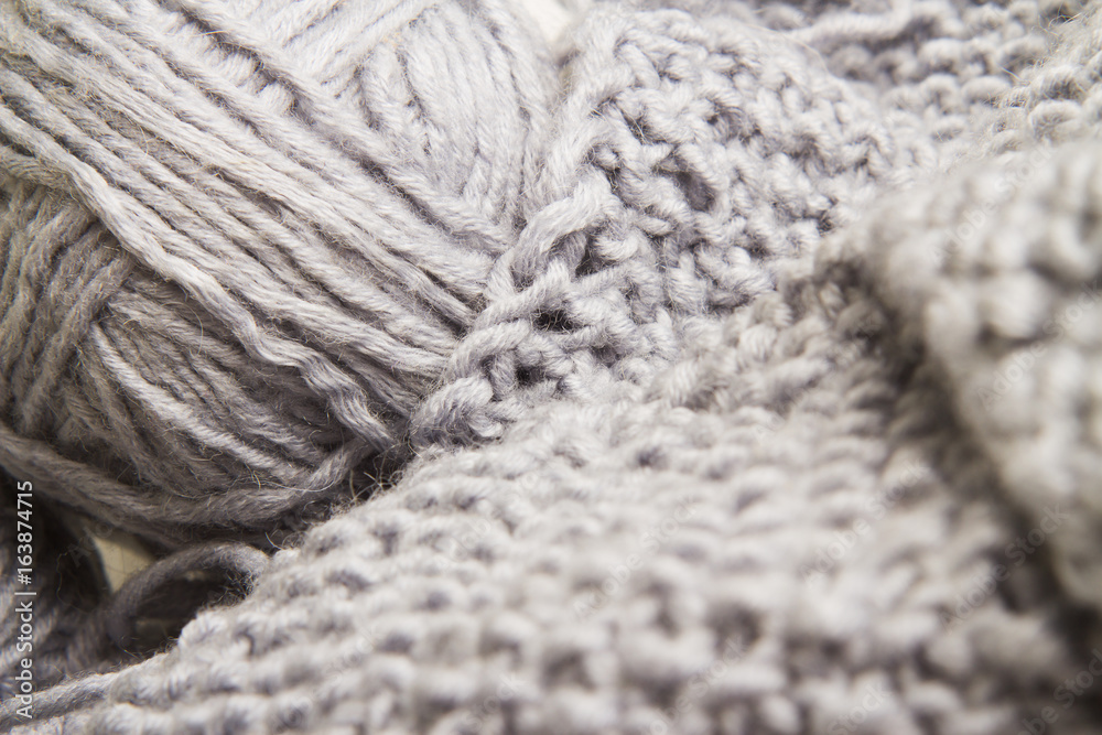 Wool yarn and wooden needles closeup