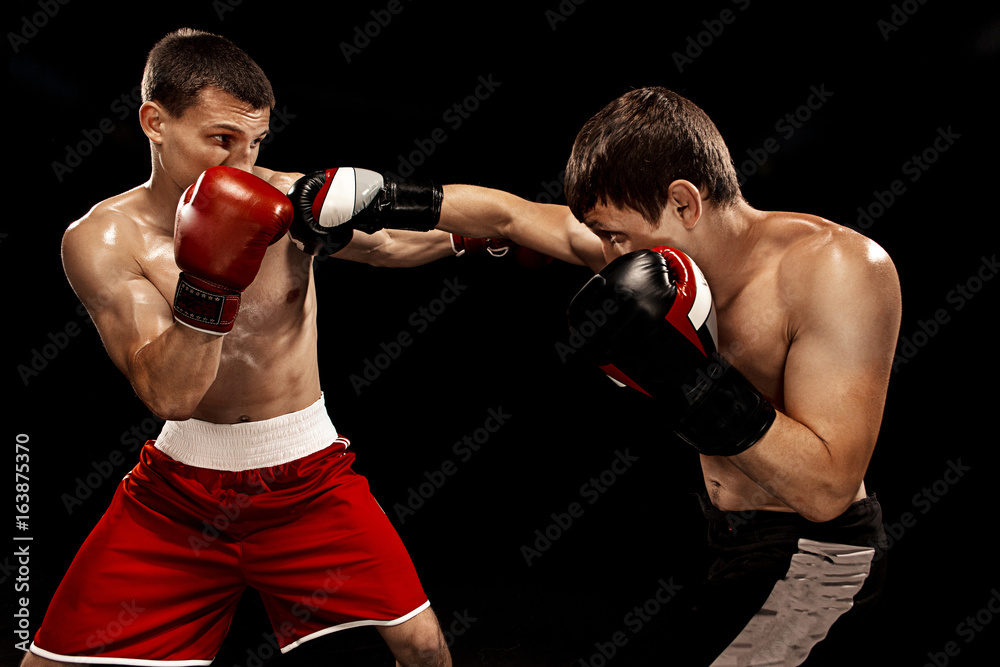 Two professional boxer boxing on black background, Two professional boxer boxing on black background,