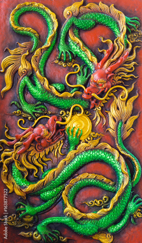 close up of the green dragon's fight on the red wall.