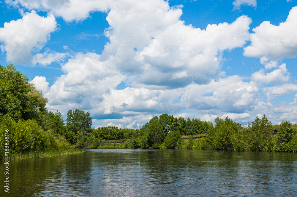Beautiful nature of Russia. The Tereshka River in summer. River, trees by the river and a beautiful cloudy sky
