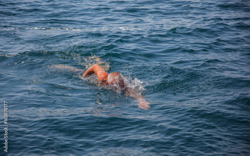 Swimming man in sea.
