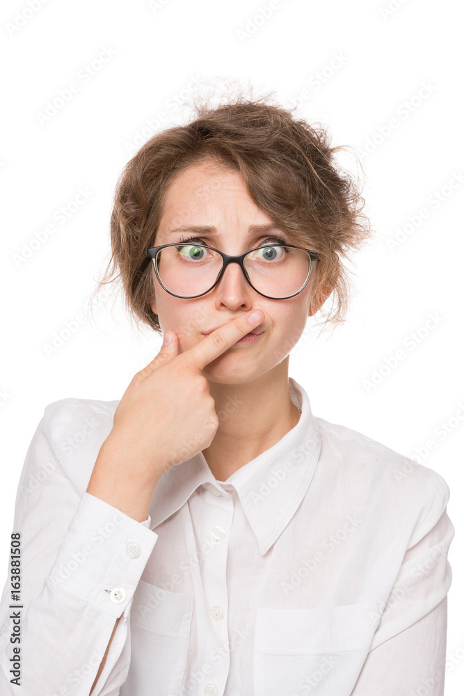 Girl in a white blouse stands on a white background, gestures, emotions on her face
