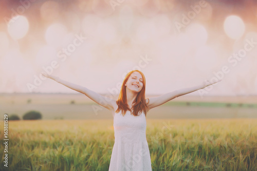 young woman on the wonderful wheat field background