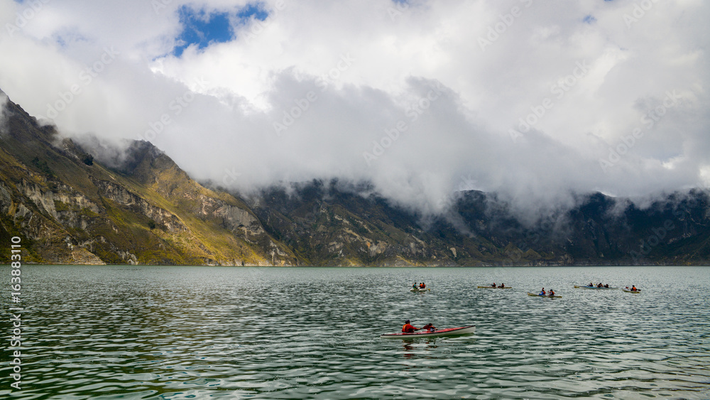 Kayaks at Quilotoa, a water-filled caldera and the most western volcano in the Ecuadorian Andes, Ecuador