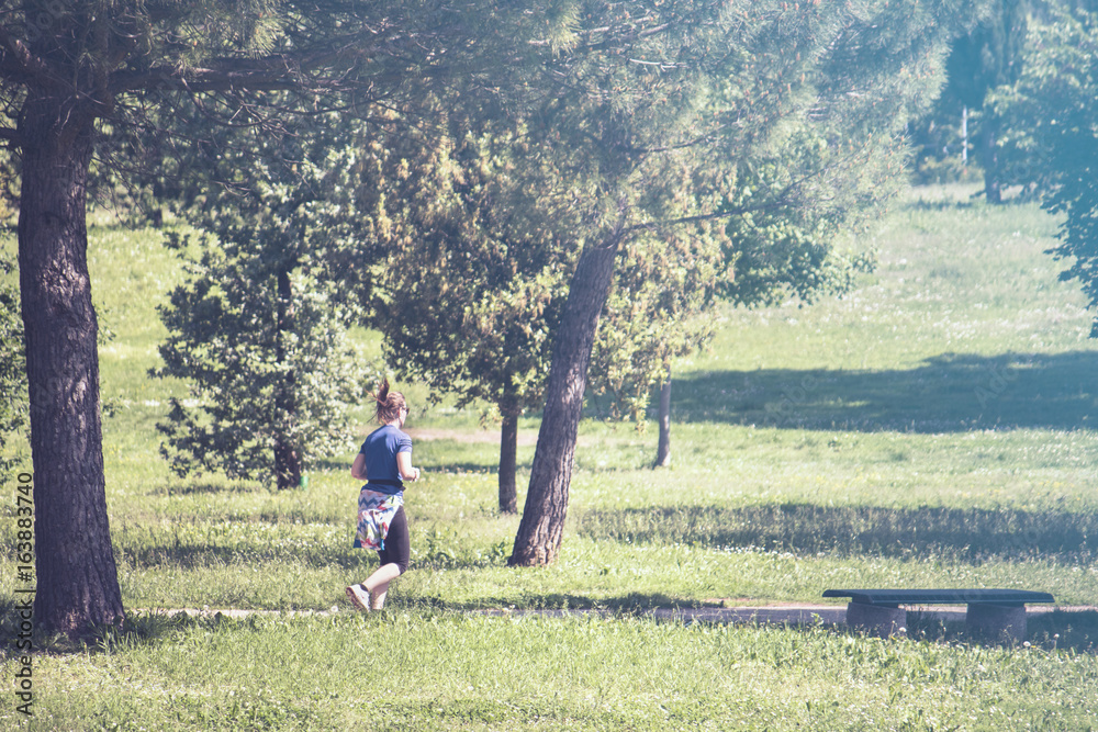 outdoor sportive running woman, jogging at park (picture vintage effect)