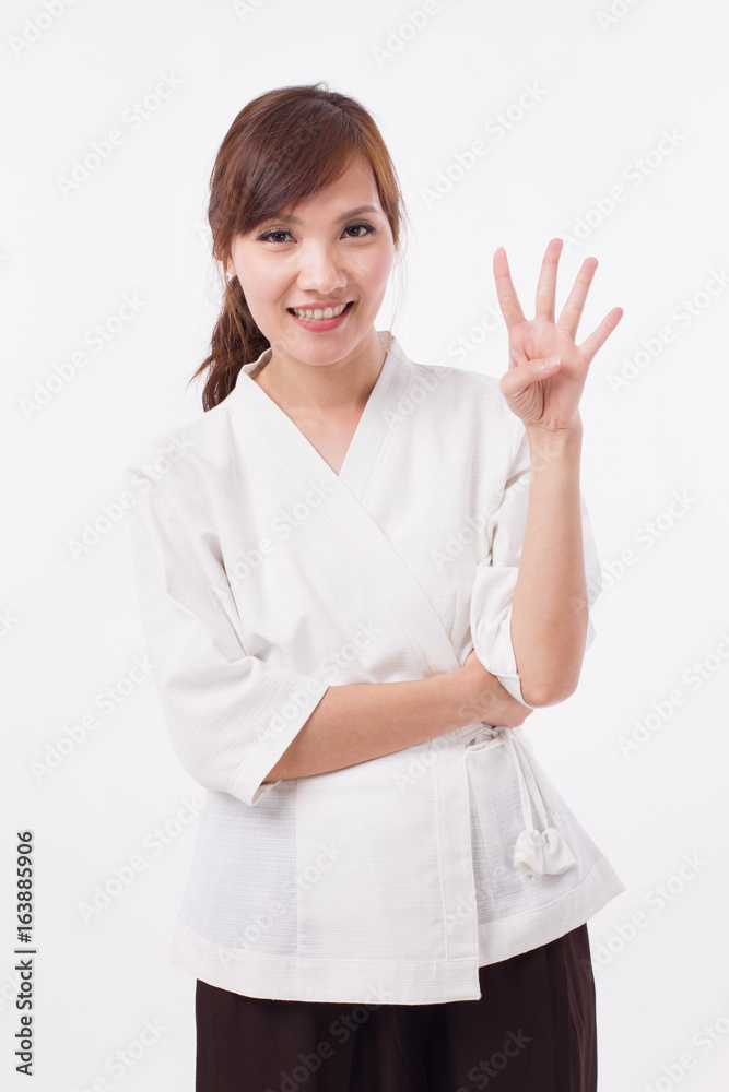 woman spa therapist pointing up 4 fingers, counting, numbering woman spa therapist pointing up 4 fingers, counting, numbering