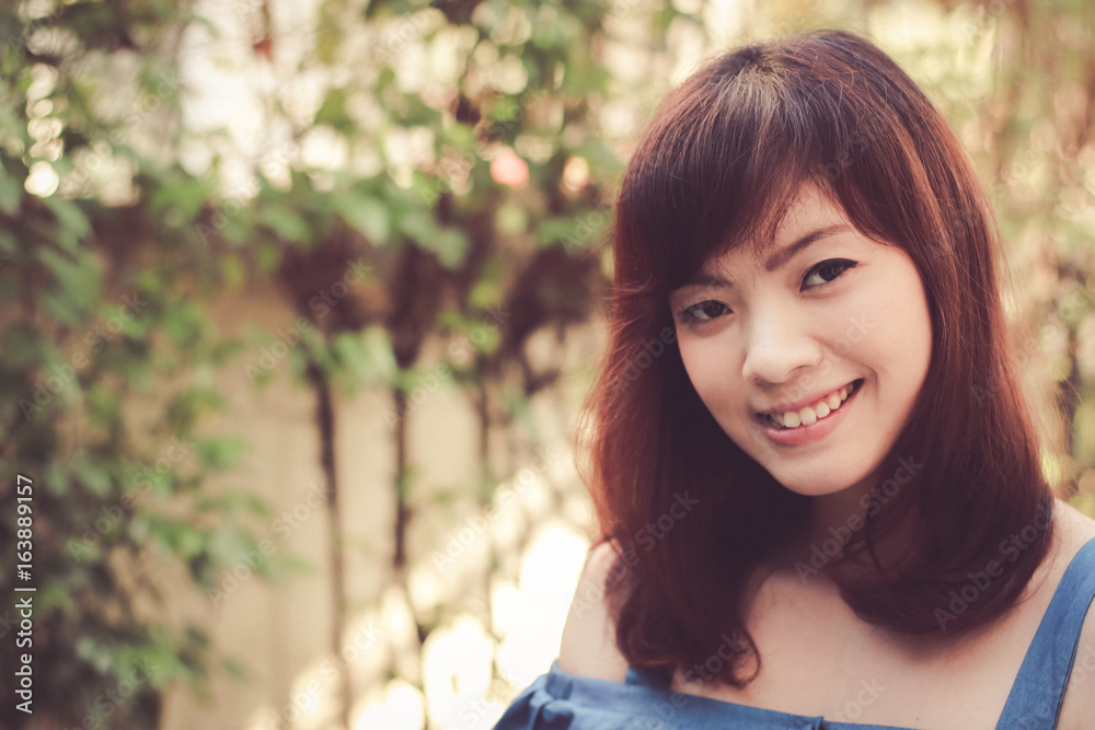Beautiful Asian woman smiling with outdoor scene, relaxing and happy concept. Beautiful Asian woman smiling with outdoor scene, relaxing and happy concept.