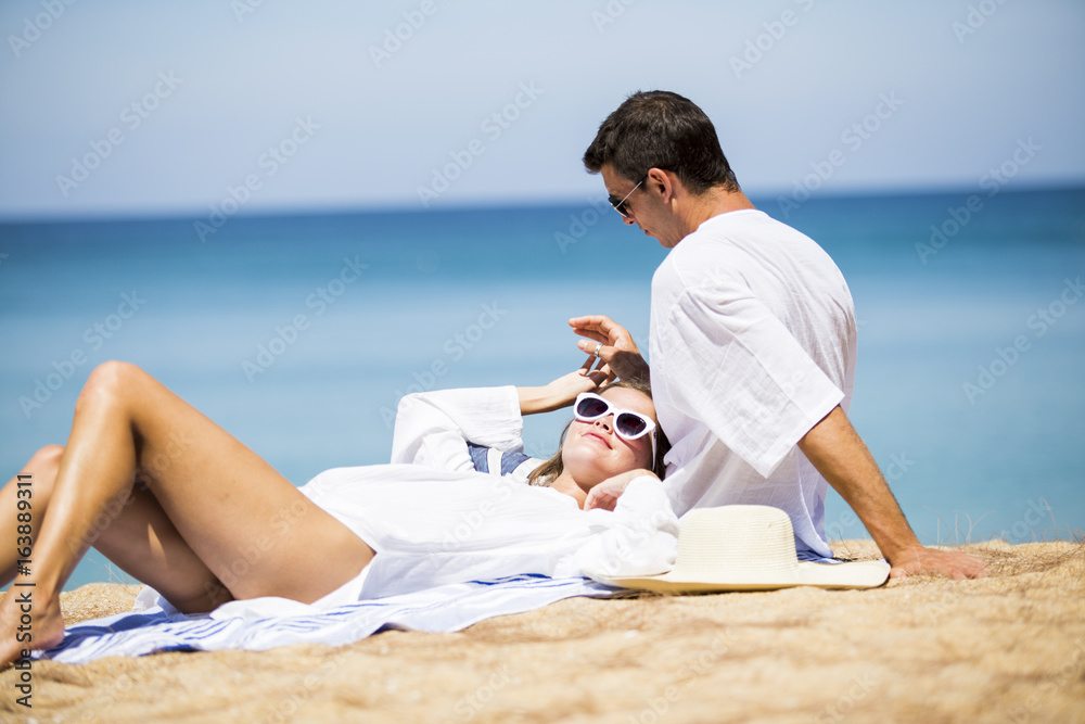 Woman and man having a good time together on seaside in summer