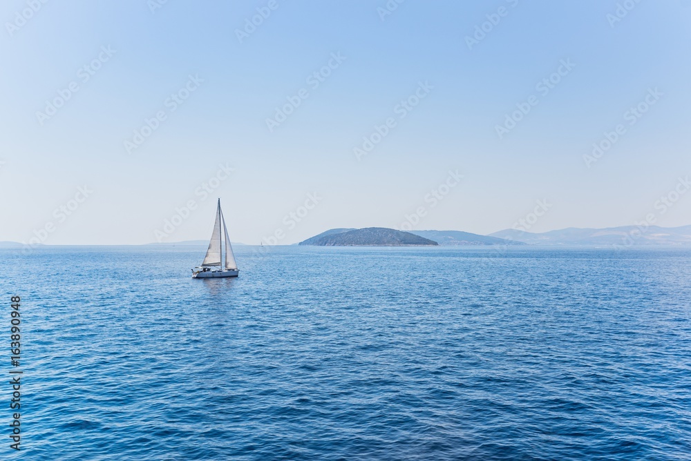 Small sailboat sailing in the calm waters
