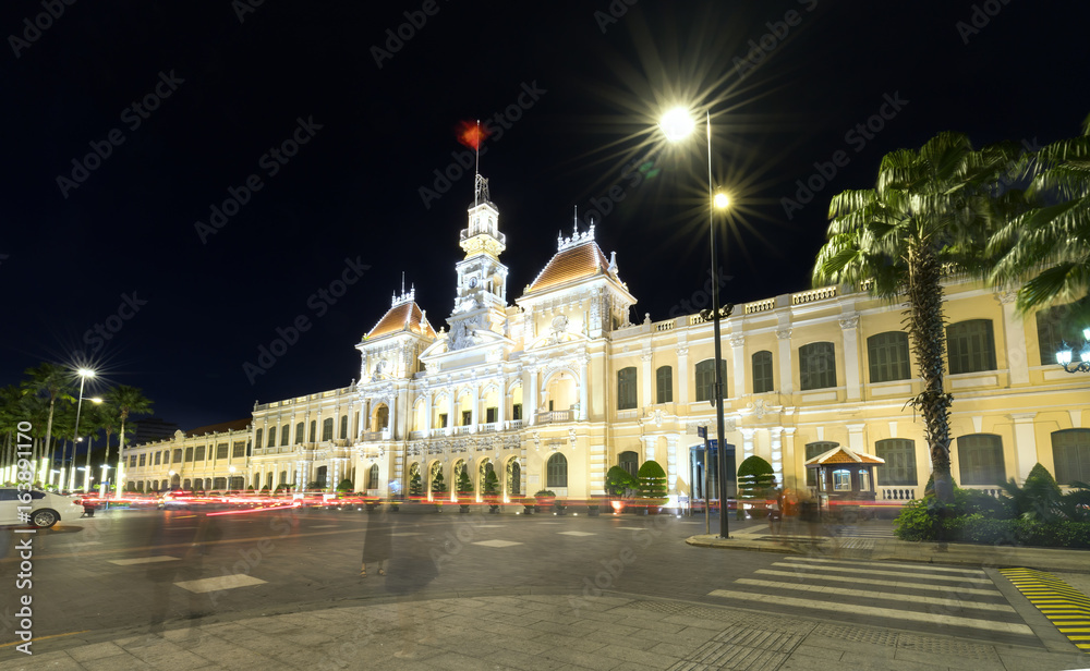 Ho Chi Minh City, Vietnam - July 9, 2017: Beautiful People's Committee Building at night with many lights illuminating buildings with ancient architecture adorn the face of Ho Chi Minh City, Vietnam. 