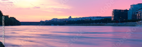 Bratislava, sunset over river Danube with River Park and Lafranconi Bridge, panorama 3:1 photo