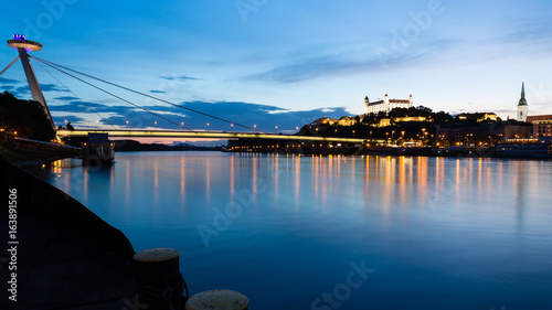 Photography Bratislava, New Bridge, Castle, Cathedral during dusk from a boat on river Danub