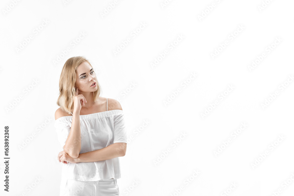 Beautiful blond woman in white blouse and pants on white background. copy spase Beautiful blond woman in white blouse and pants on white background. copy spase