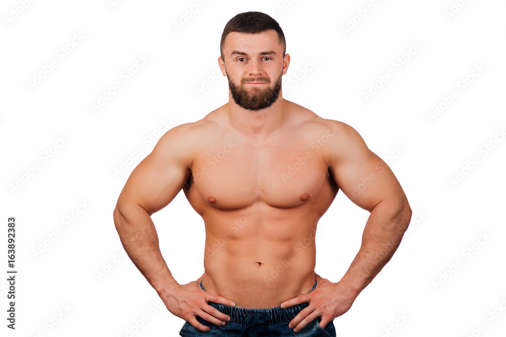 Portrait of a strong bearded male fitness model, torso. White background, isolate. hands on his hips. Portrait of a strong bearded male fitness model, torso. White background, isolate. hands on his hips.