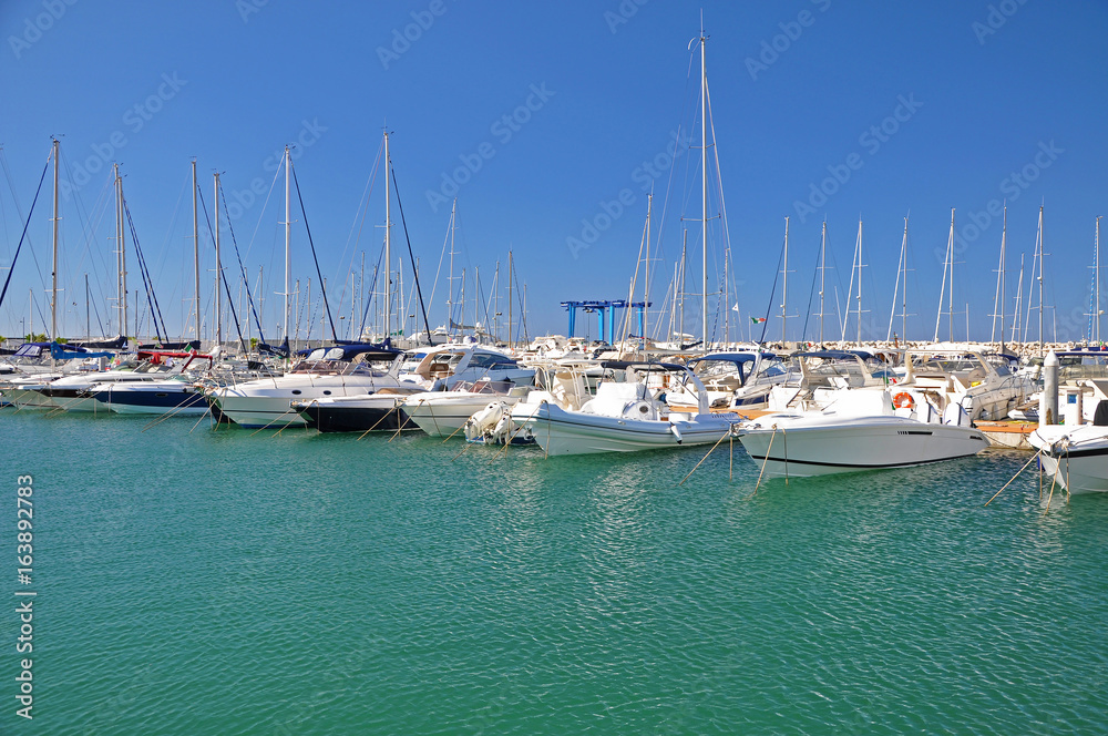 Sunny morning in the marina of Salerno with white yachts