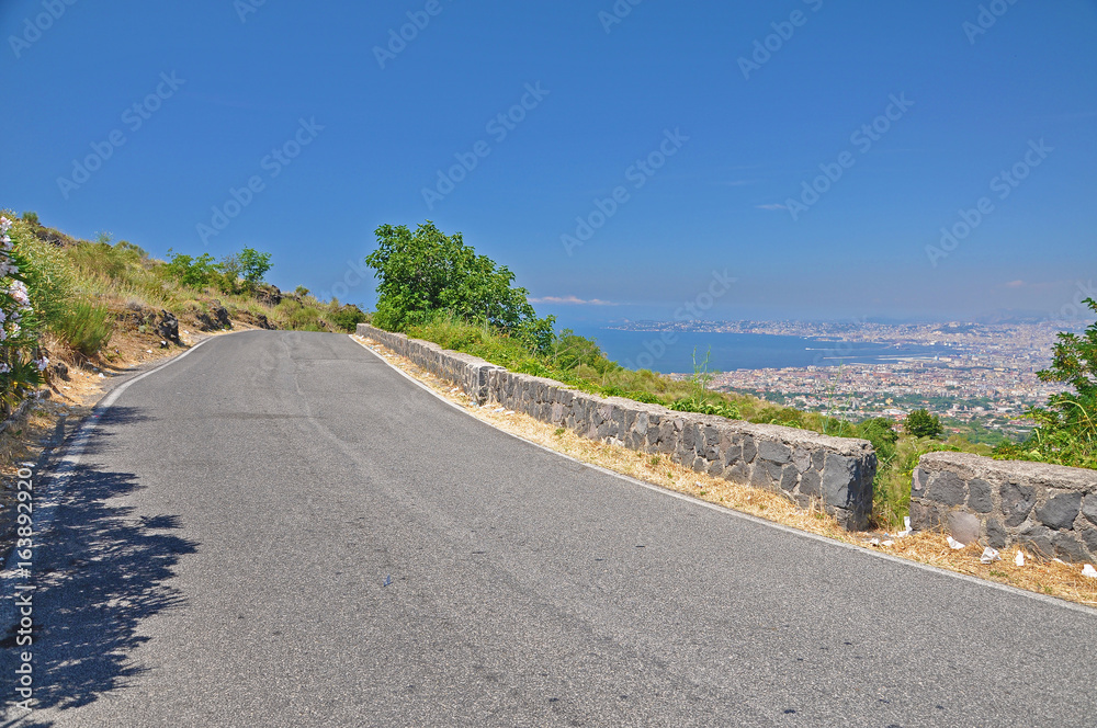 The road leading to the volcano mount Vesuvius and the panorama of the city of Naples