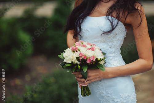 Bride holding big wedding bouquet on wedding ceremony