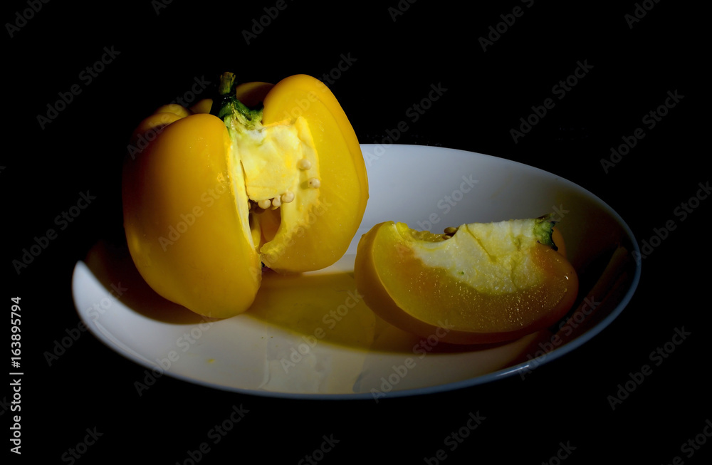 Yellow bell pepper on dish