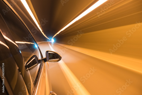 car driving fast exit the tunnel