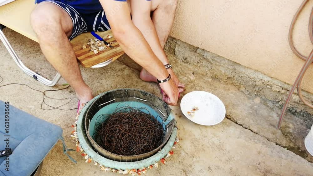 Fisherman preparing shellfish baits onto hooks for fishing slow-motion HD Fisherman preparing shellfish baits onto hooks for fishing slow-motion HD