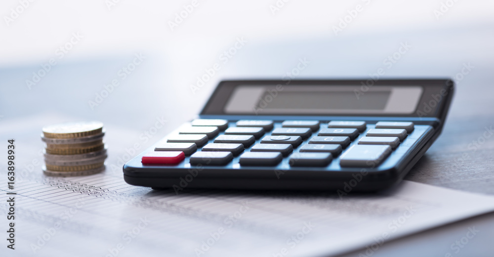 Calculator on financial documents, accounting concept Calculator on financial documents, accounting concept