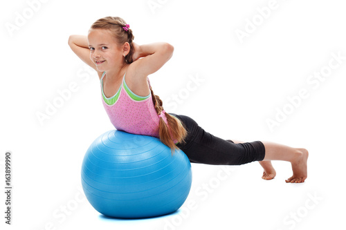 Young girl doing back strengthening gymnastic exercises