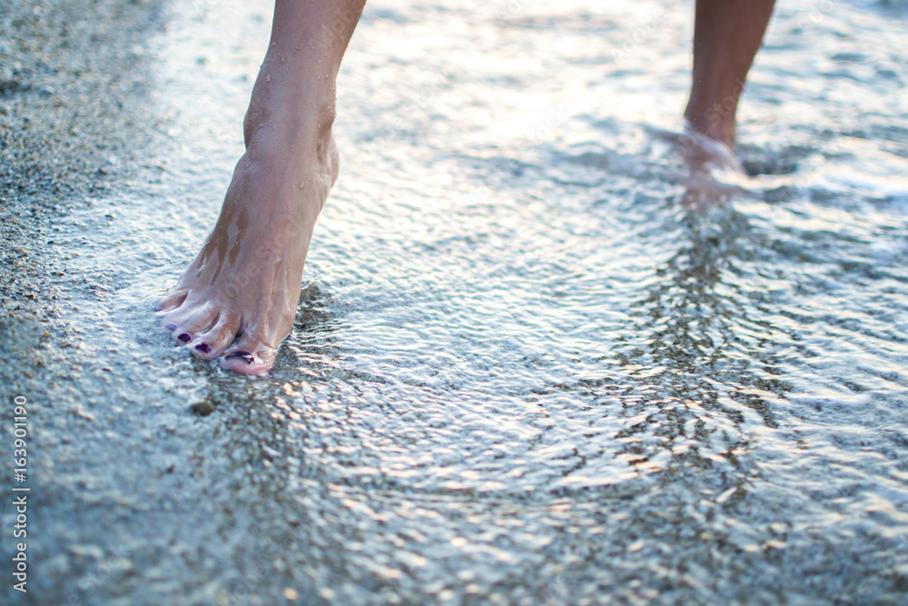 Close up of woman legs walking on the beach. Close up of woman legs walking on the beach.