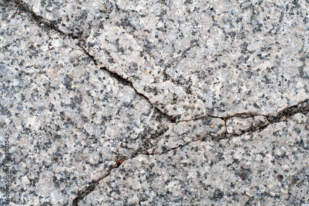 cracked gray granite stone. background, texture cracked gray granite stone. background, texture