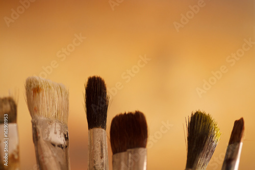 Artistic brushes in the workshop. Brushes artist on an abstract blurred background in the studio for artists.