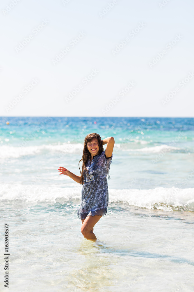 Sexy summer outdoor style beach sea vacation portrait of hot tanned beautiful sporty girl in tunic Sexy summer outdoor style beach sea vacation portrait of hot tanned beautiful sporty girl in tunic