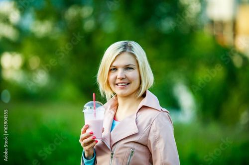 Woman in park with milkshake