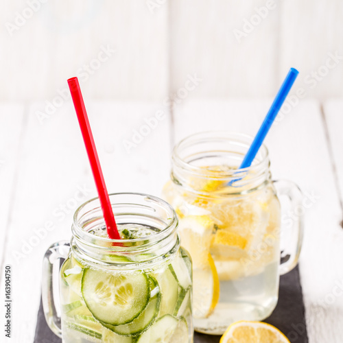Two mugs of infused detox diet refreshing waters: with cucumber and lemon