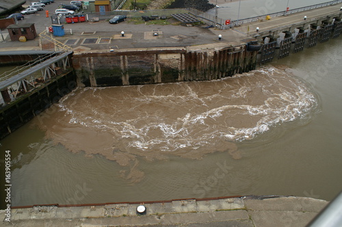 cargo ship manovering our of the dock through lock gates photo