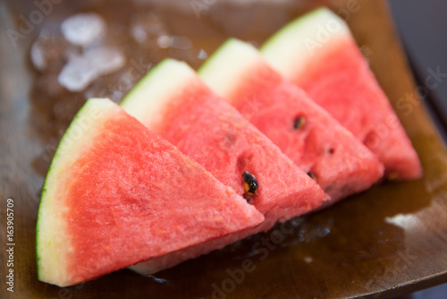 Watermelon slices on a wood ceramic plate