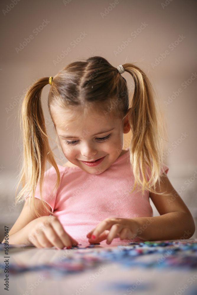 Girl playing puzzle.