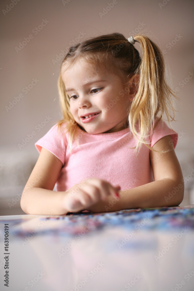 Girl playing puzzle. Girl playing puzzle.