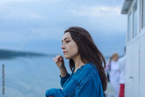Wallpaper Mural Summer happy portrait beautiful woman girl caucasian asian blended in blue shirt posing on background sky lake water sunset long hair brunette outdoors Torontodigital.ca