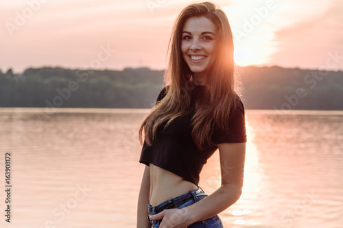 Summer spring portrait of young beautiful woman smile in the park sunset