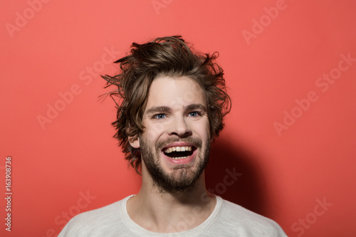 happy man with long stylish uncombed hair, morning and barbershop © Volodymyr