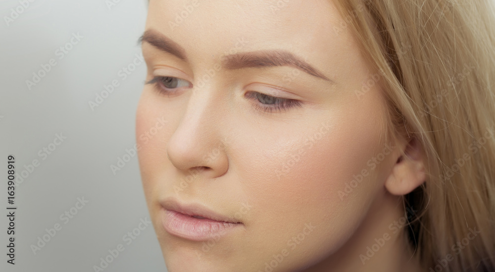 Girl with makeup foundation on adorable face Girl with makeup foundation on adorable face