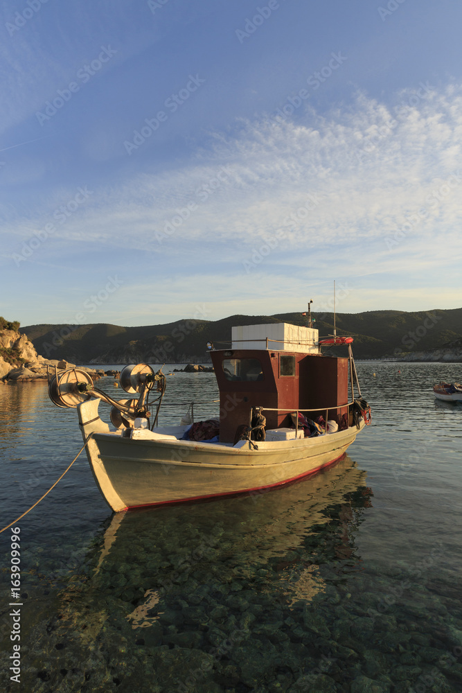 Traditional Greek fishing boats in the natural bay, Colorful boats in Aegean sea, Photo of beautiful blue sea with floating boats and nature