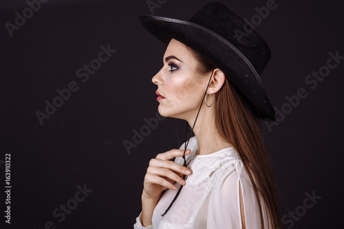 Portrait of a beautiful woman in cowboy's hat
